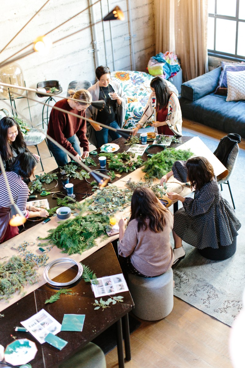 A group of women crafting together at a large table