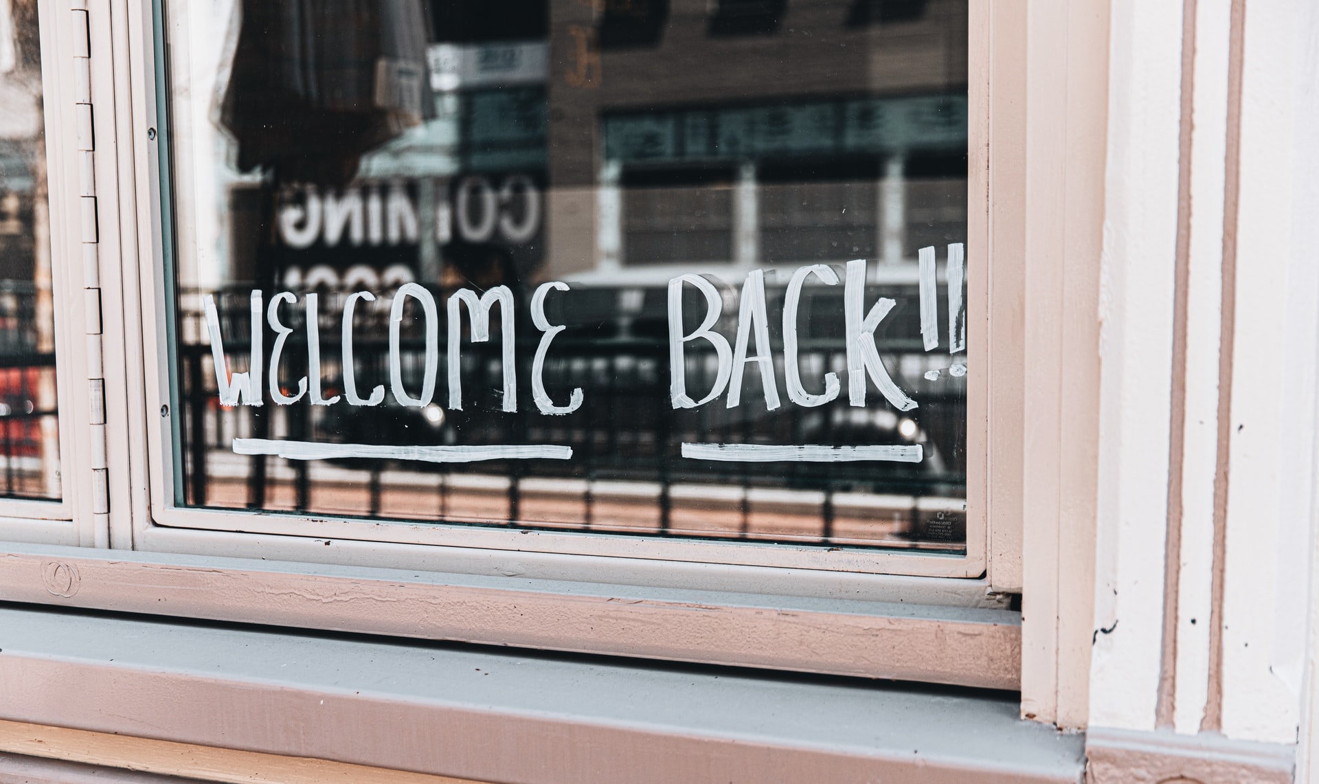window sign says welcome back